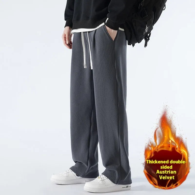 Men's double-sided polar fleece winter sports trousers in apricot colour, showing loose fit and drawstring waistband.