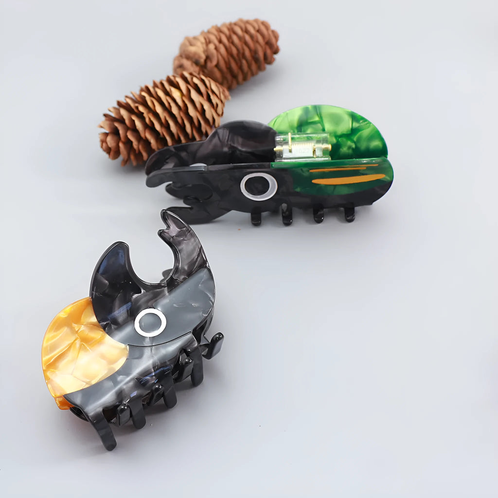 Handmade cellulose acetate Beetle Grip educational tool showing cartoon beetle and caterpillar designs