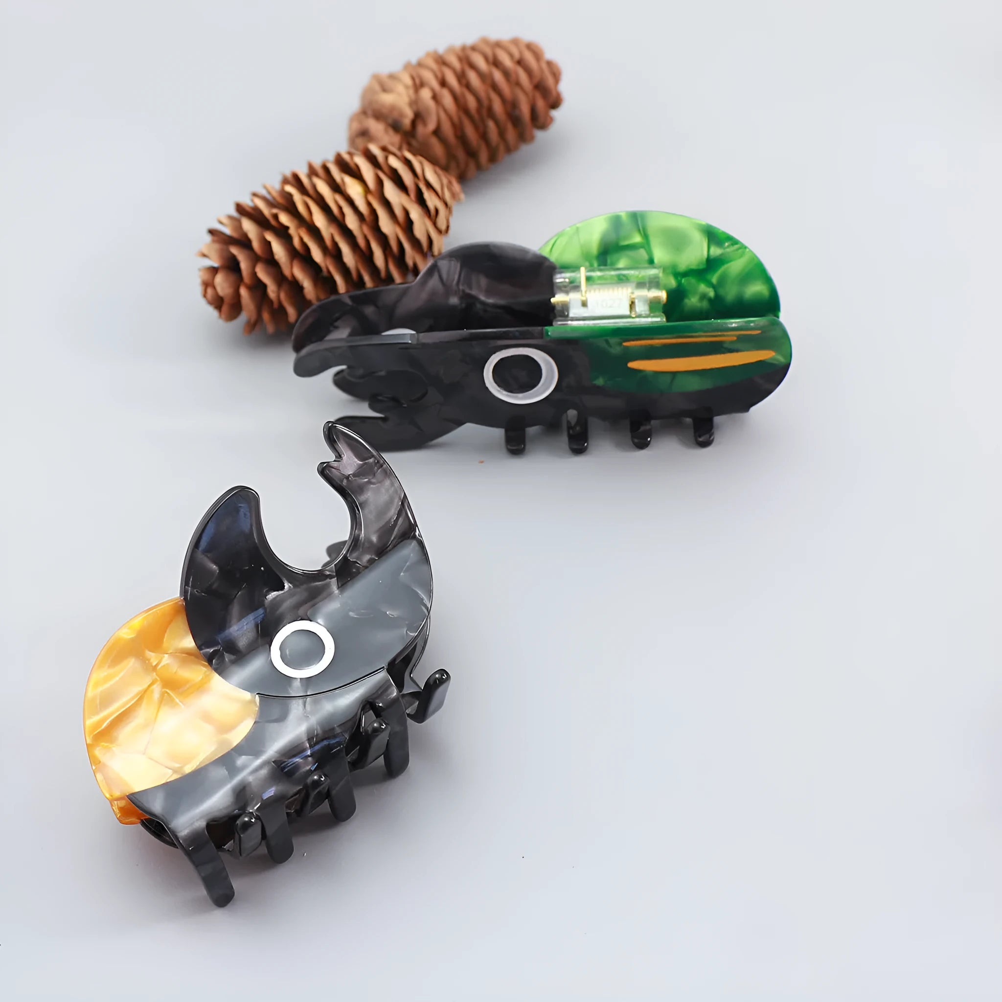 Handmade cellulose acetate Beetle Grip educational tool showing cartoon beetle and caterpillar designs