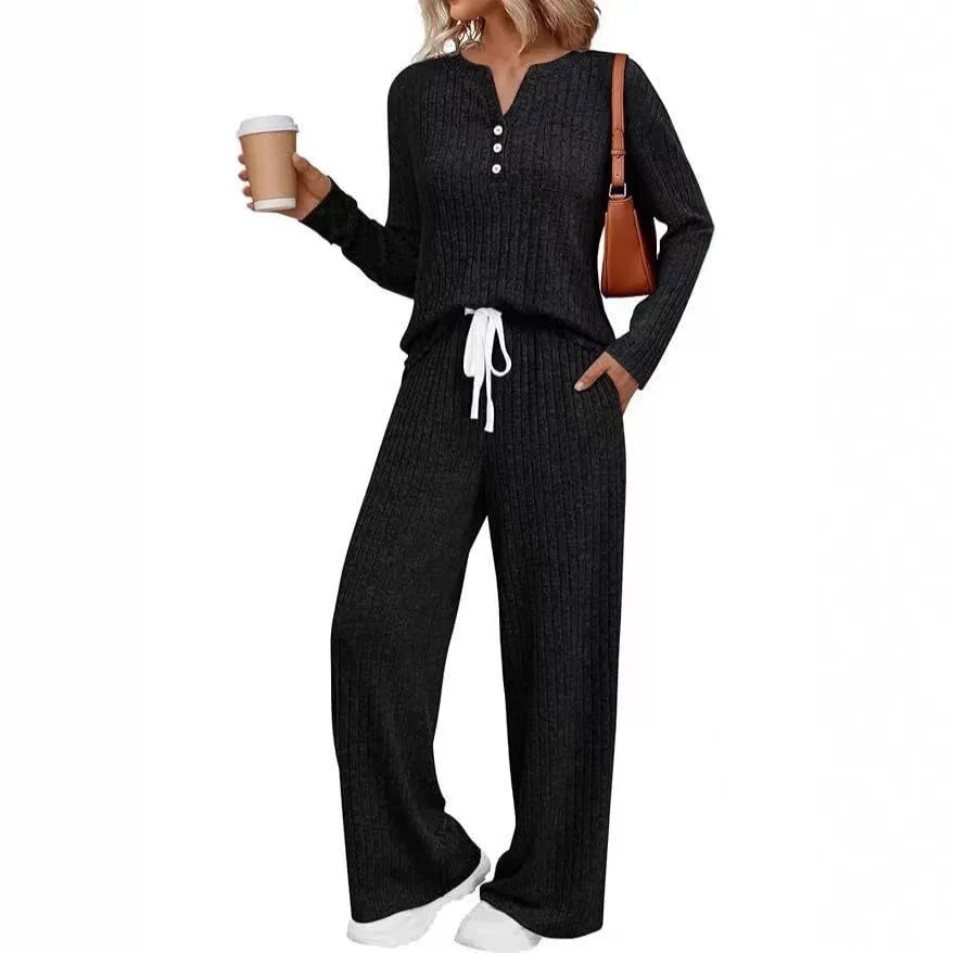 Woman wearing a striped V-neck knit long coat with lace-up detail and pants from a casual streetwear set.