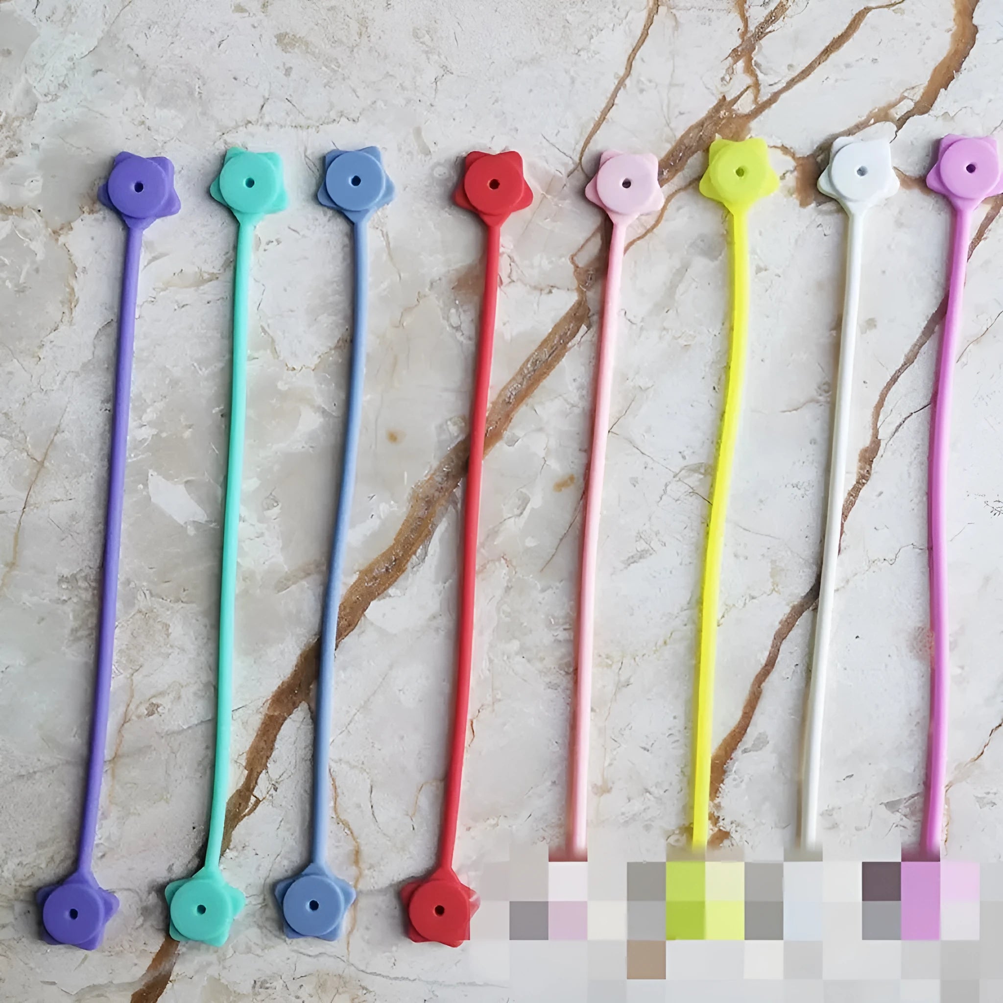 Small silicone magnet wire winder in purple organizing a headphone cable