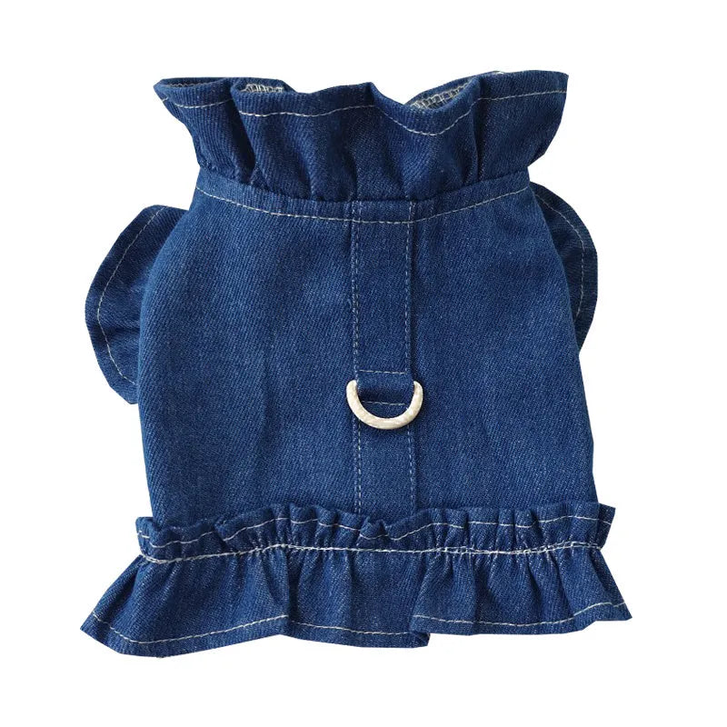 Blue denim dog dress with ruffles and a chest harness leash hook on a mannequin.