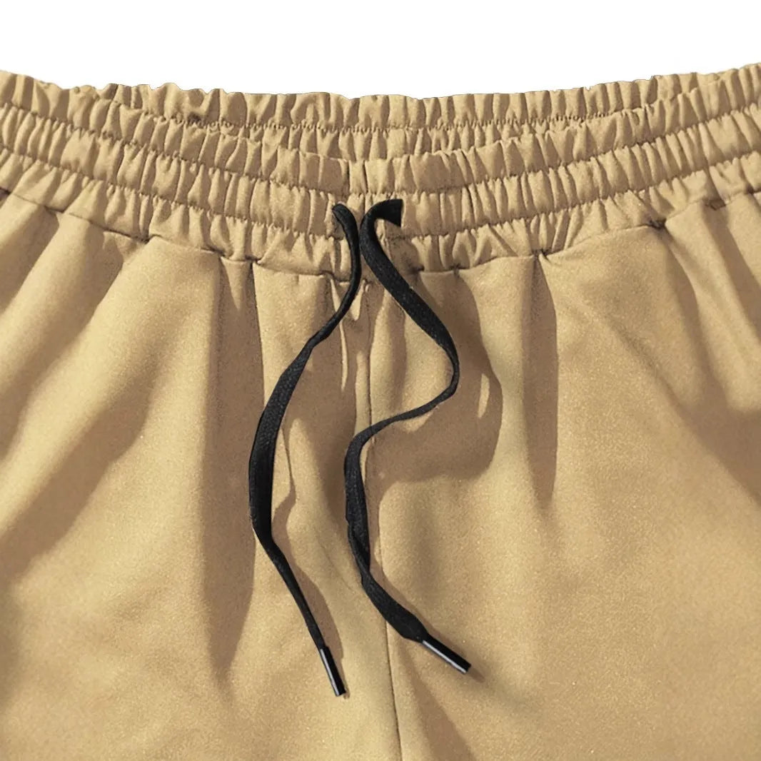 Men's khaki sports shorts with coconut palm leaf print, elastic waistband, straight cut design
