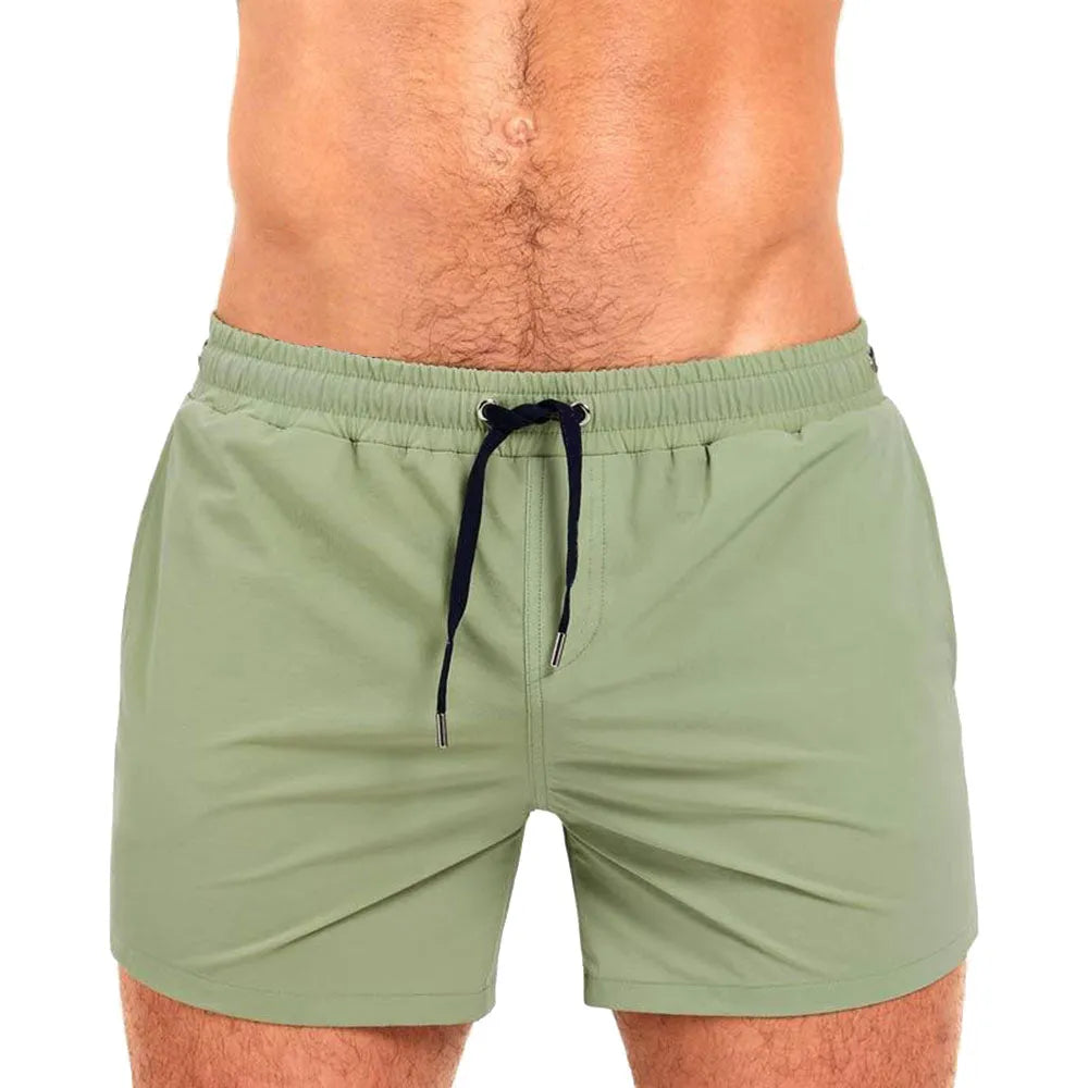 Men's solid colour polyester swimming shorts with mesh lining shown in multiple colours