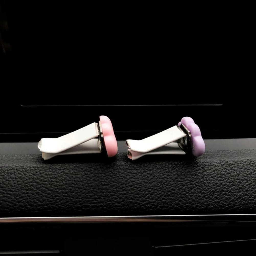 Resin Baiyun cartoon car fragrance clip in multiple colours attached to vehicle air vent measuring 17mm x 27mm