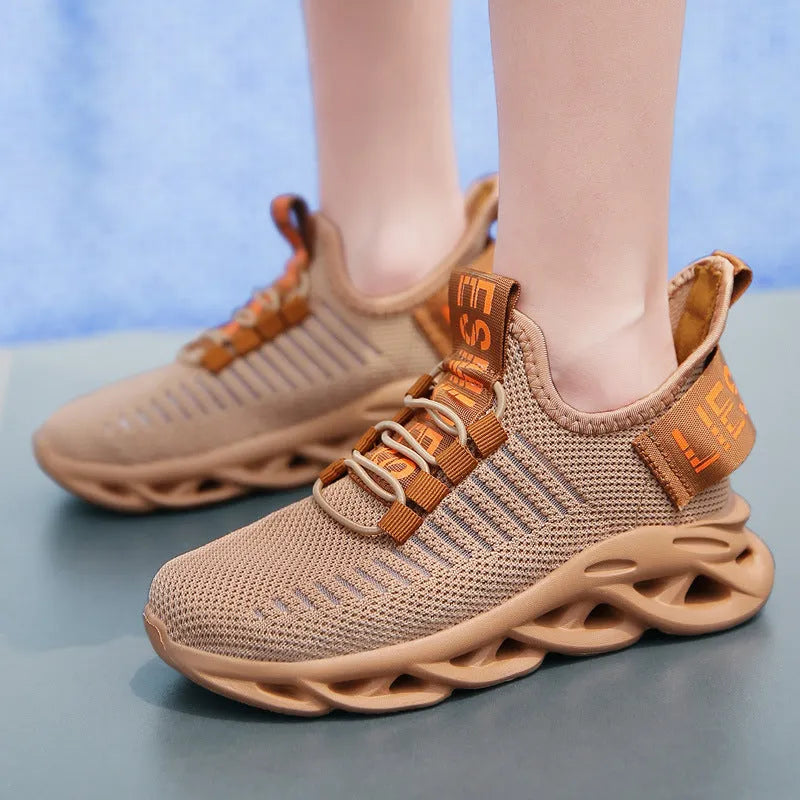 Children's black coconut sneakers with Velcro strap and fabric upper.