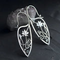 Silver rhinestone earrings with lotus vine design featuring geometric floral shapes and round crystal elements