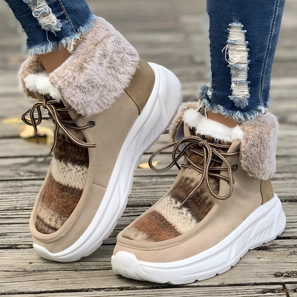 Women's beige lace-up snow boots with suede upper and fur lining on a white background.
