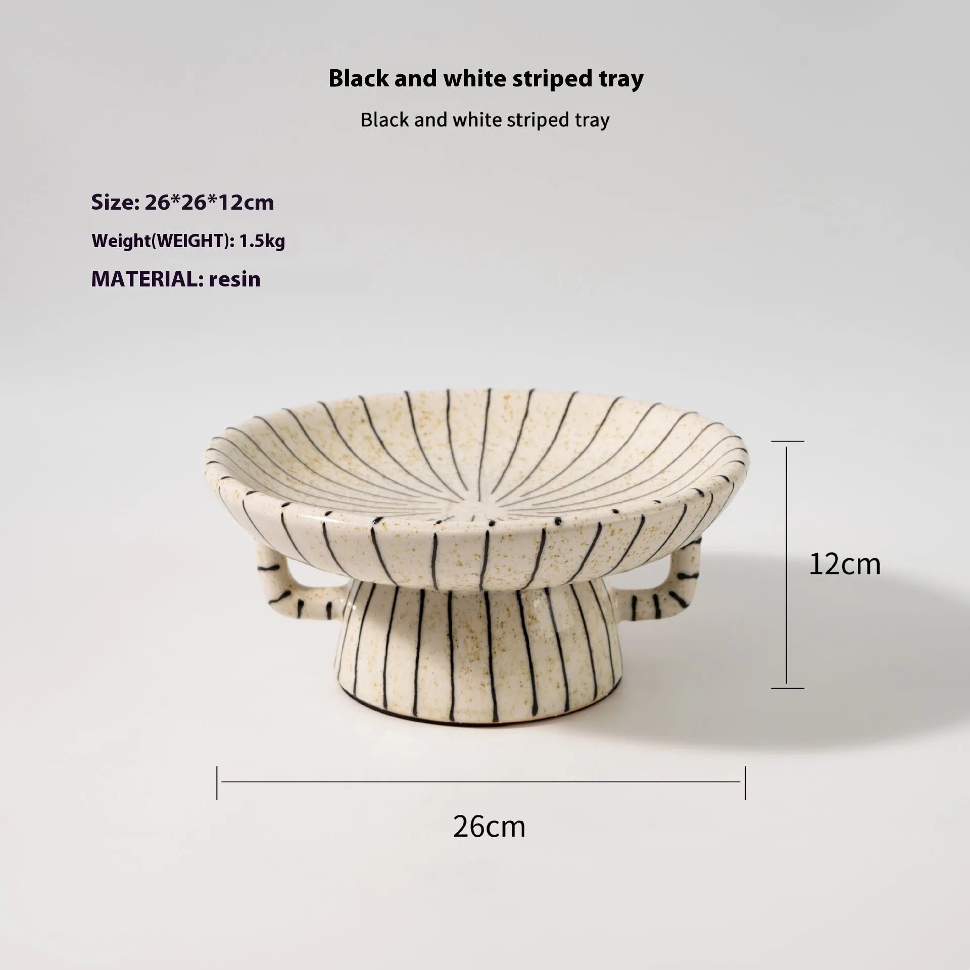Black and white striped synthetic resin fruit plate on a wooden table.