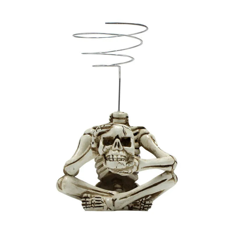 Gothic skull design resin bracket for holding soilless Tillandsia air plants on wall.