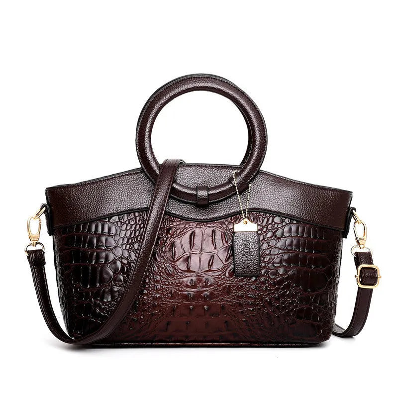 Fabric women's handbag showing multiple zipper compartments and organisational pockets