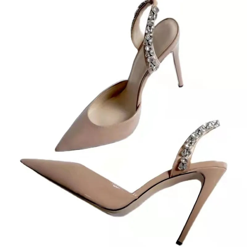 Women's pointed toe high heel sandals with rhinestone side detail on patent leather upper.