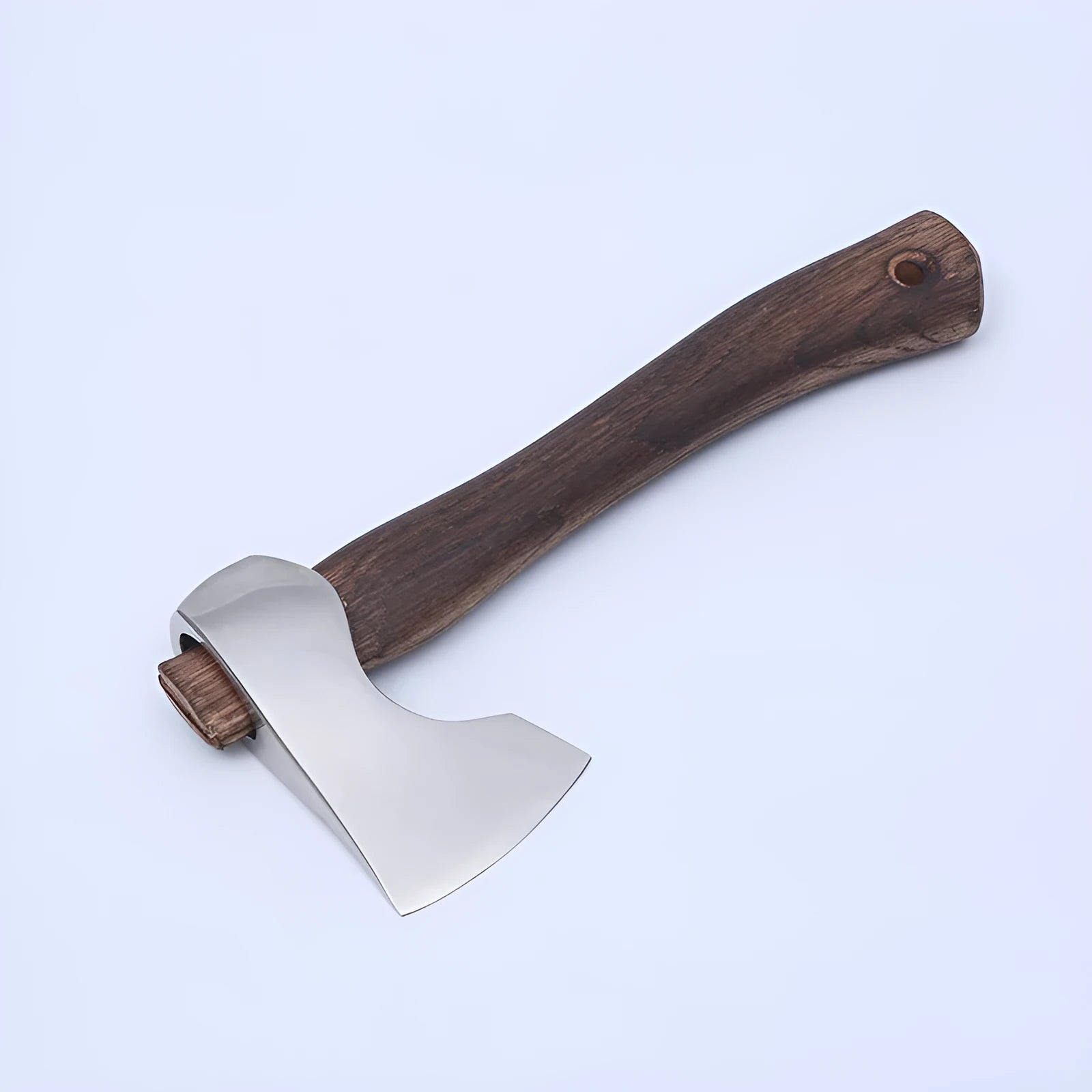 Camping axe with high carbon steel head and wooden handle on solid background