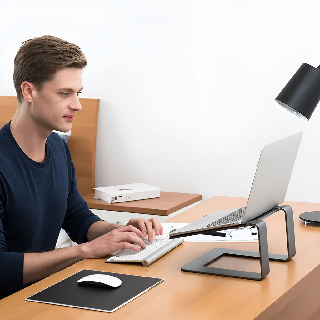 Black aluminium alloy laptop stand on desk with laptop elevated