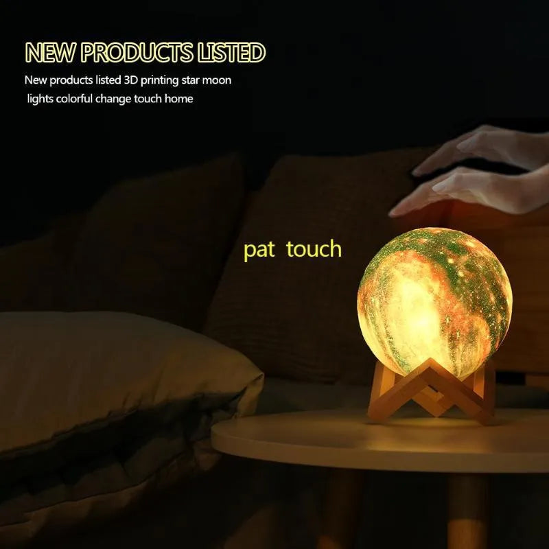 3D printed spherical moon night light with colour changing LED glow on a dark surface.