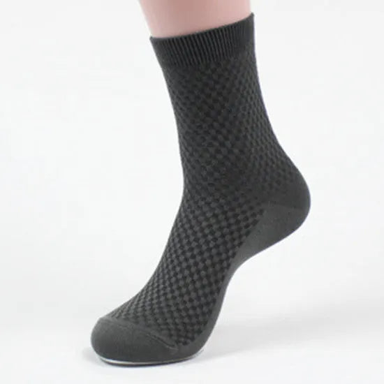 Men's bamboo fibre business socks in small square pattern, shown in classic colours on a grey background.