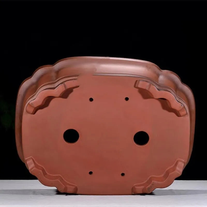 Large antique-finish purple clay flowerpot with raised tree stump and floral design.