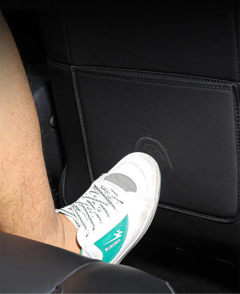Pair of black leather car seat kick pads showing single pocket and full 68cm by 42cm coverage