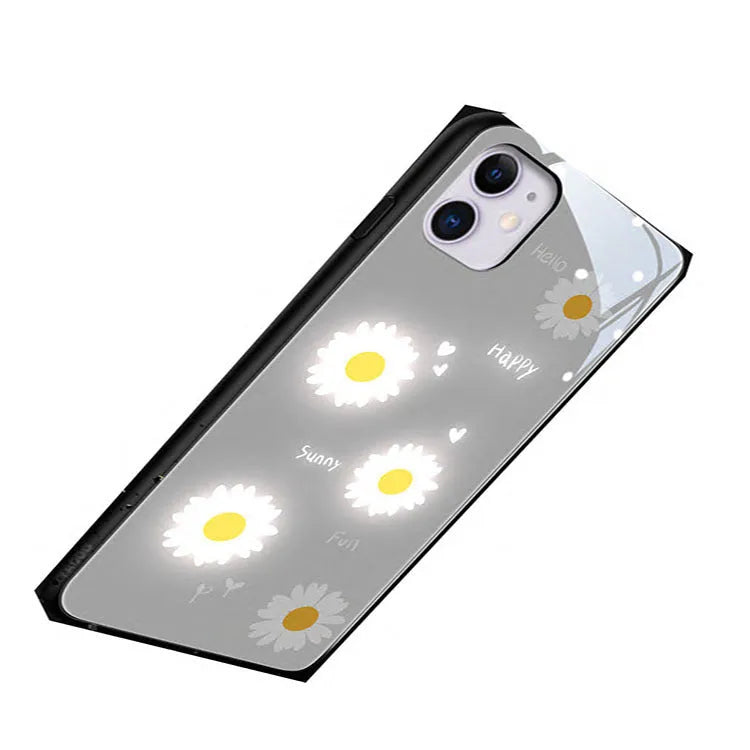Luminous white daisy design iPhone case with voice-activated colour lights on a phone