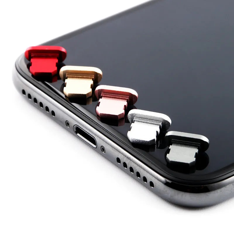 Aluminium alloy dust plug for iPhone charging port in a selection of colours including gold, silver, and rose gold.