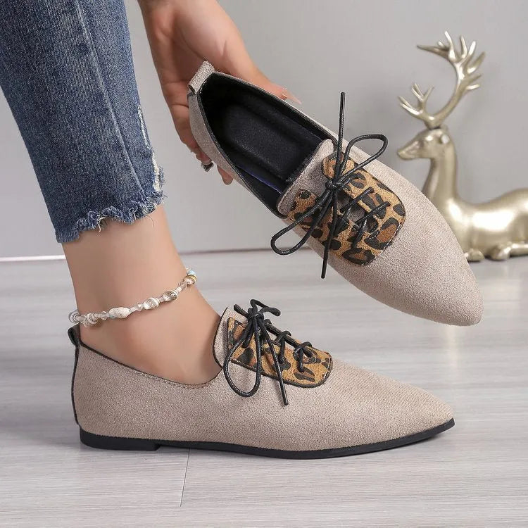 Beige leopard print women's pointed toe high heel pumps with a rubber sole.