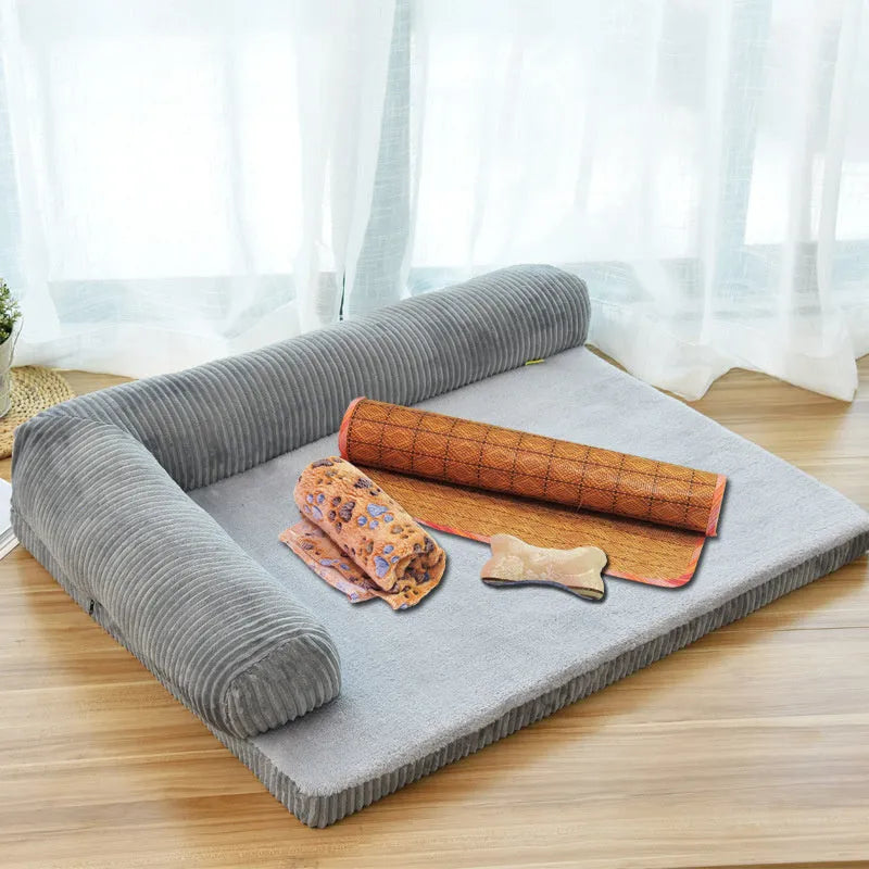 Grey corduroy dog sofa bed with raised sides and a non-slip base on a wooden floor.