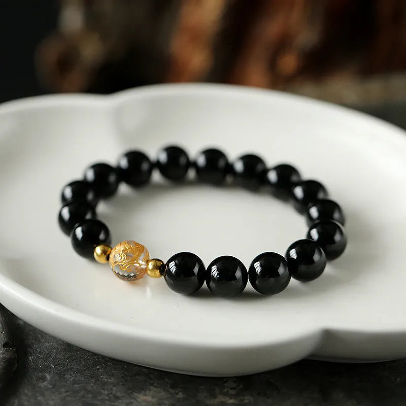 Geometric unisex bracelet with obsidian, black agate, and white crystal beads and dragon charm