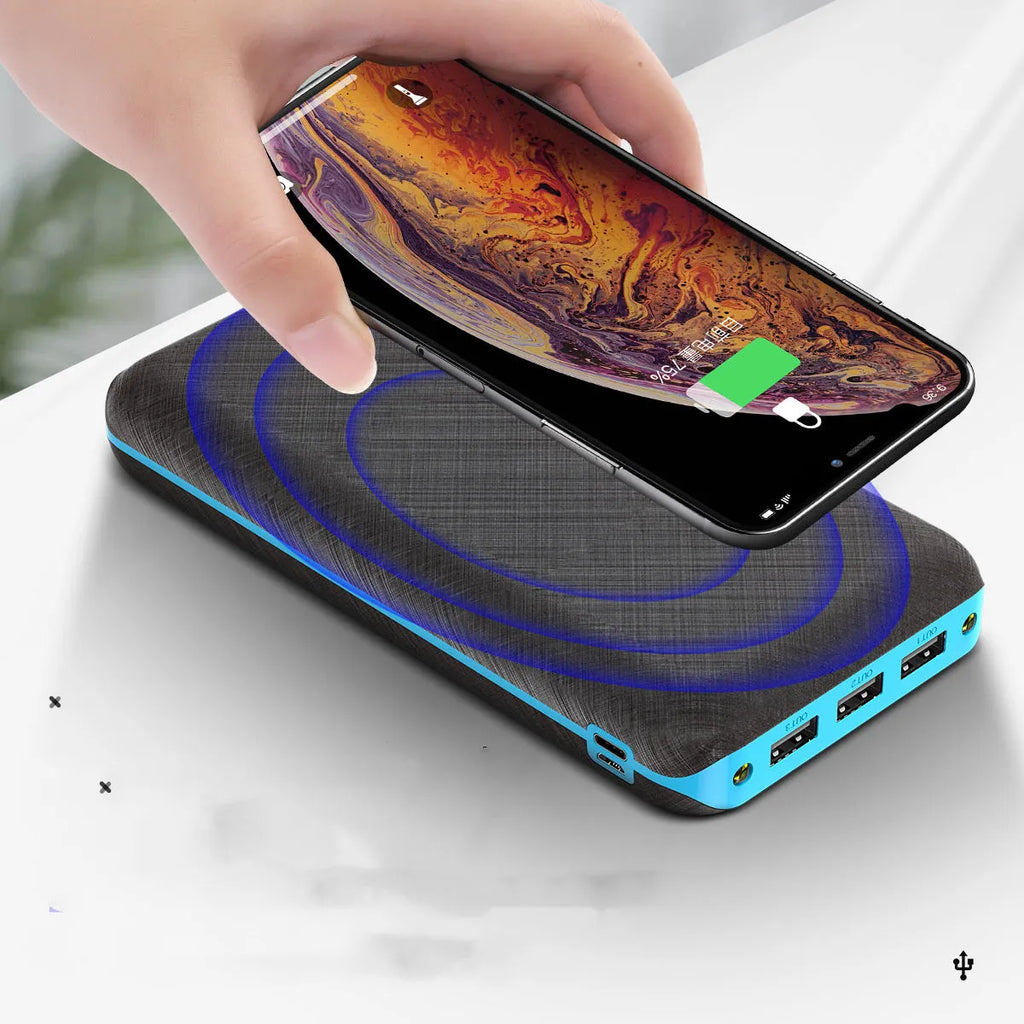 Black solar power bank with wireless Qi charging pad, three USB ports, and an LED flashlight