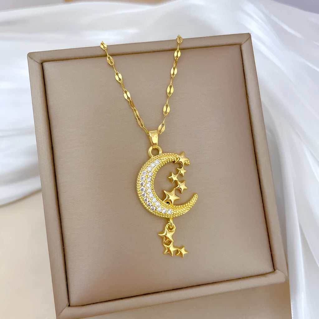 Geometric moon pendant necklace with tassel detailing and diamond accents on copper