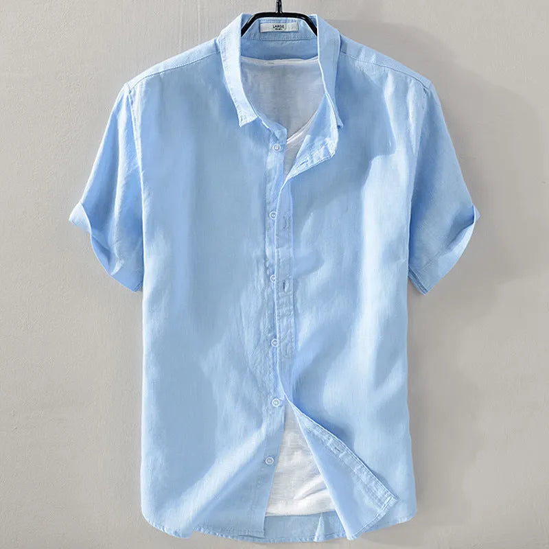 Man wearing a light apricot coloured loose fit short sleeve linen shirt for casual leisurewear.