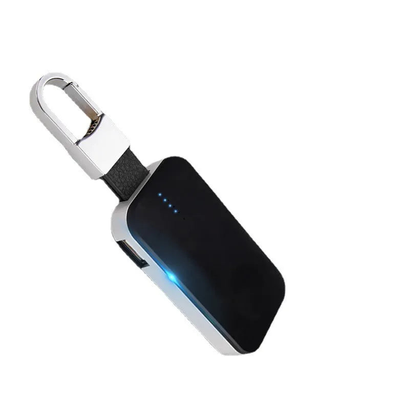 Black Apple Watch portable wireless charger keychain with USB port on a keyring.