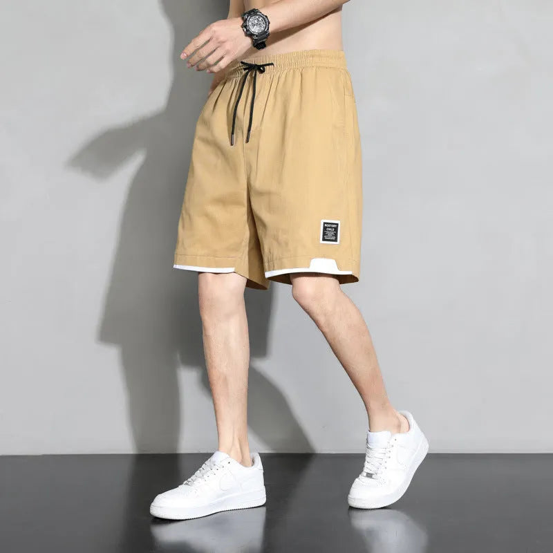 Boys' black cotton shorts in a plus size on a hanger