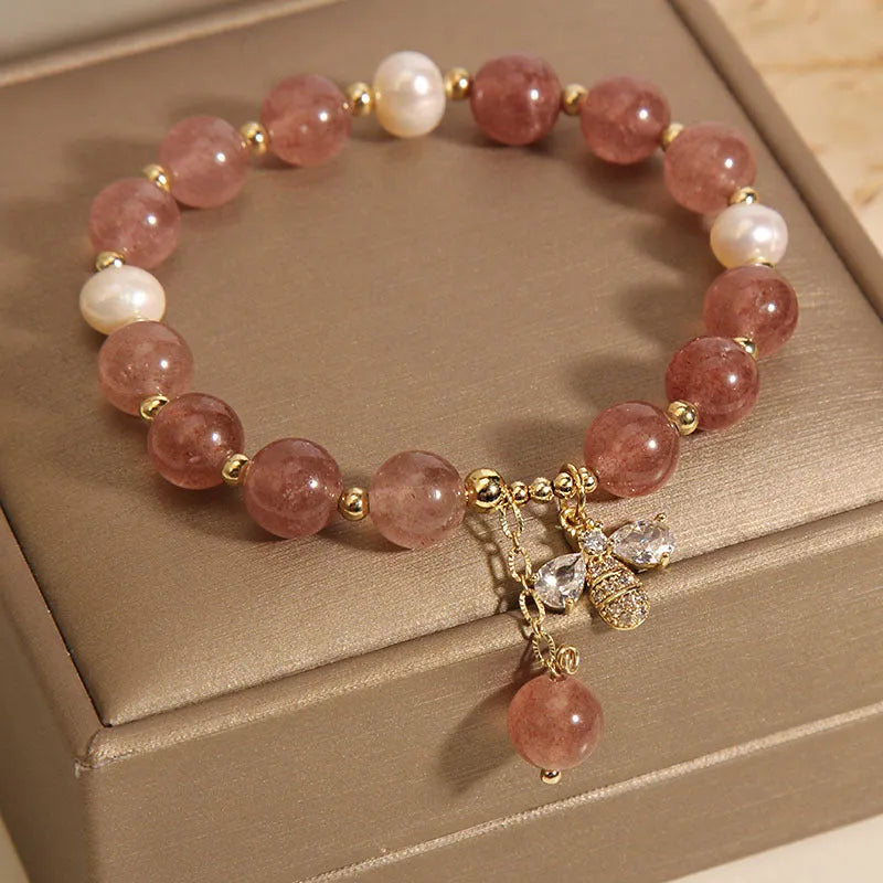 Freshwater pearl and strawberry quartz bracelet with zircon accents on wrist
