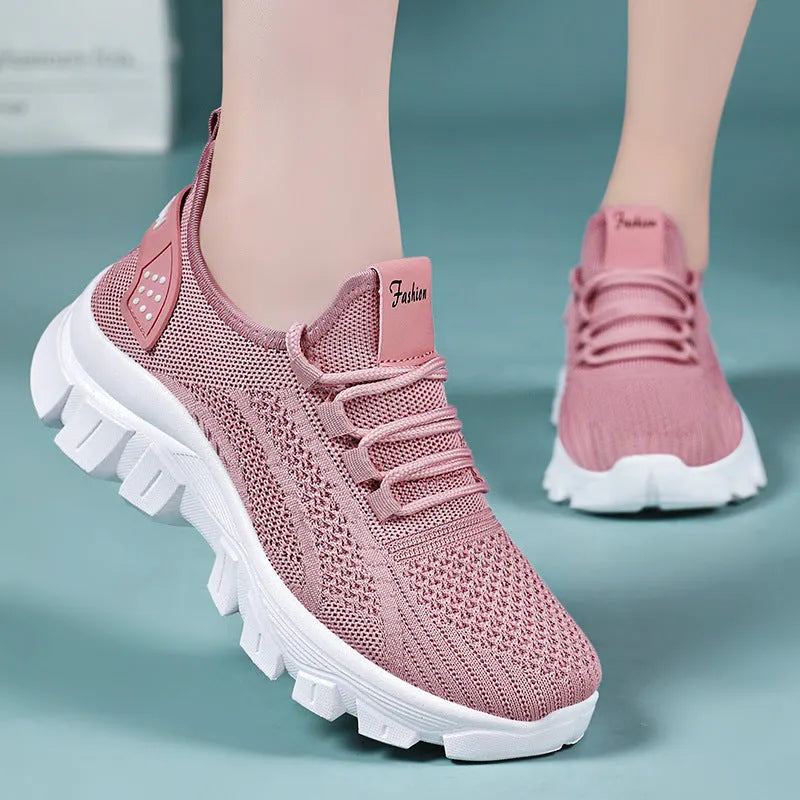 Women's white flyknit sneakers with round toe and flat PVC sole