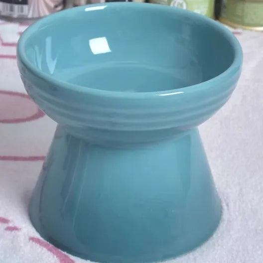 Ceramic pet bowl with high foot design showing anti-tumble stability feature