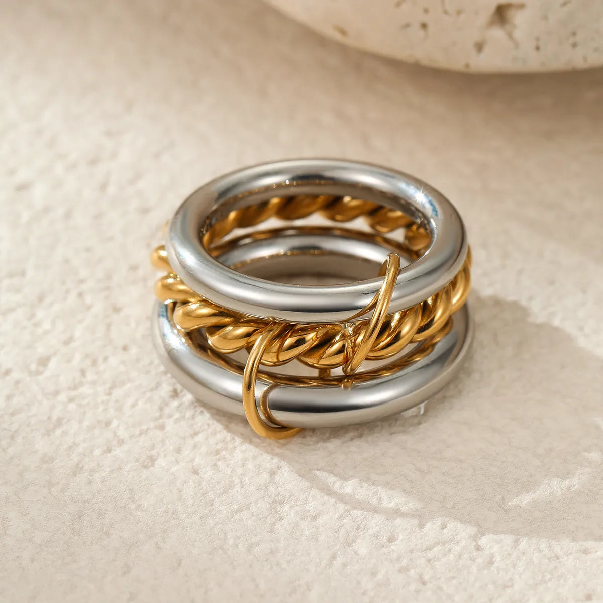 Gold plated stainless steel stacked ring set for women in an exaggerated design.