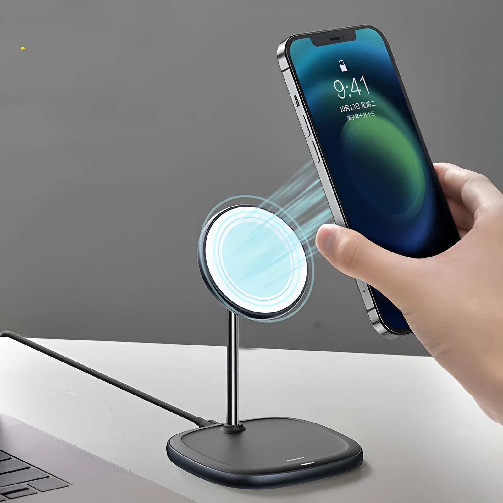 Black Swan magnetic wireless charging stand holding an iPhone 12 upright on a desk