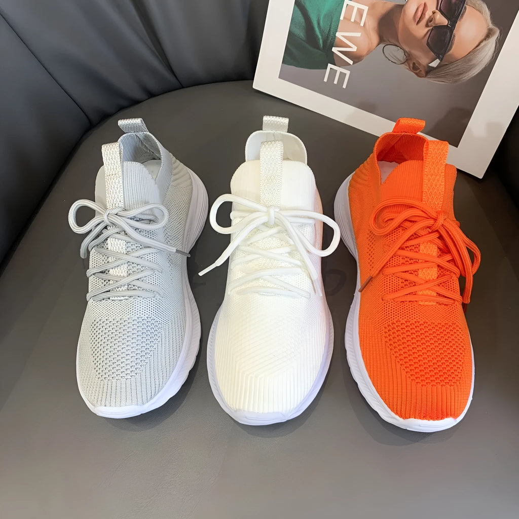 Women's Flyknit mesh running shoes in creamy white colour showing low-top slip-on design and rubber sole.