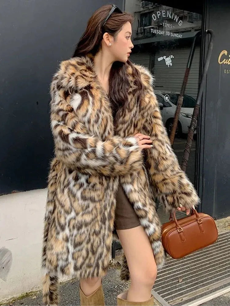 Women's grey faux fur mid-length winter coat with a fur collar and pockets on a model.