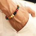 Natural stone beaded bracelet with lava stone charms on wrist, showing ethnic design and 18cm unisex fit.