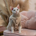Lambswool plush cat vest with buckle fastening on a cat showing side view