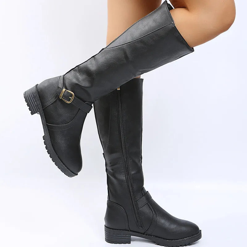 Women's knee-high knight boots in black with a square heel and a silver belt buckle detail on the side.