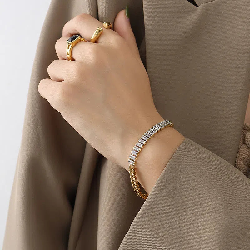 Gold titanium steel geometric matte finish unisex bracelet on flat surface