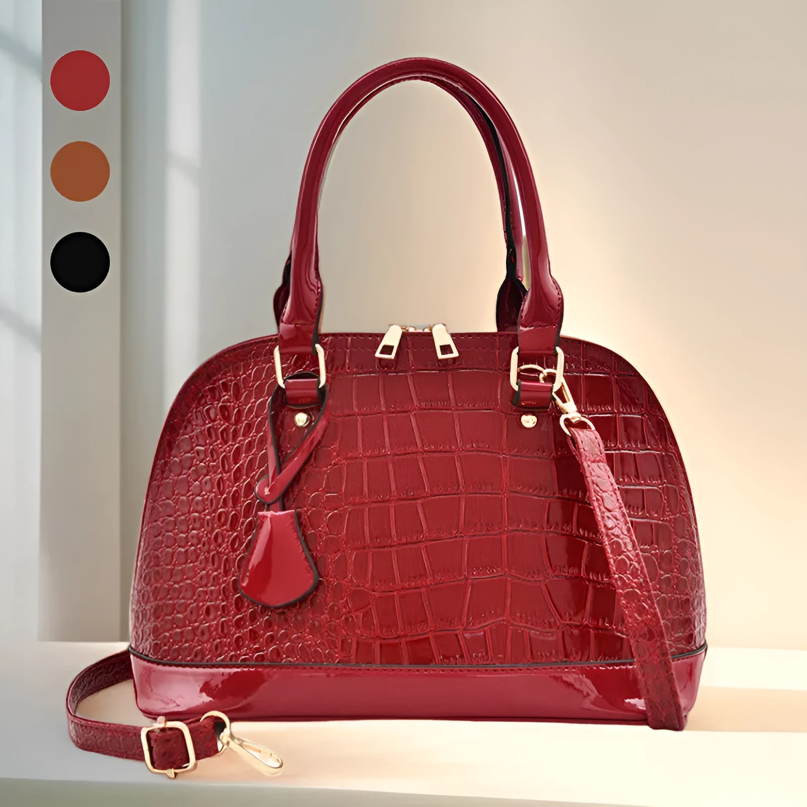 Large shiny black crossbody shoulder bag showing structured shell shape and dimensions