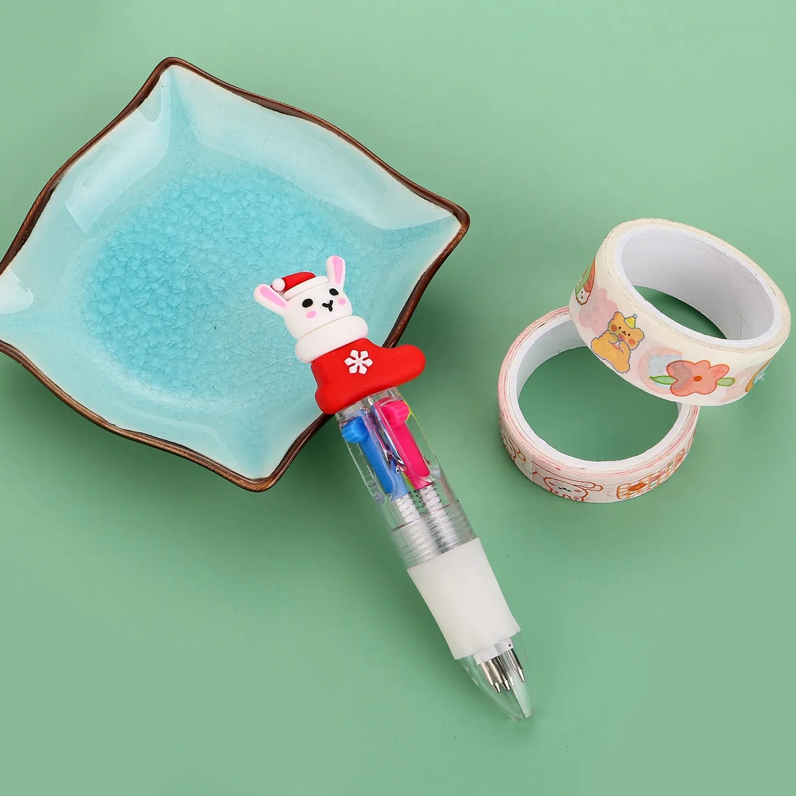 Christmas mini four-colour press-action ballpoint pen with festive designs measuring 11 cm.