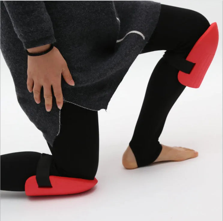 A pair of thick black EVA foam knee pads for garden kneeling, showing size and cushioning.