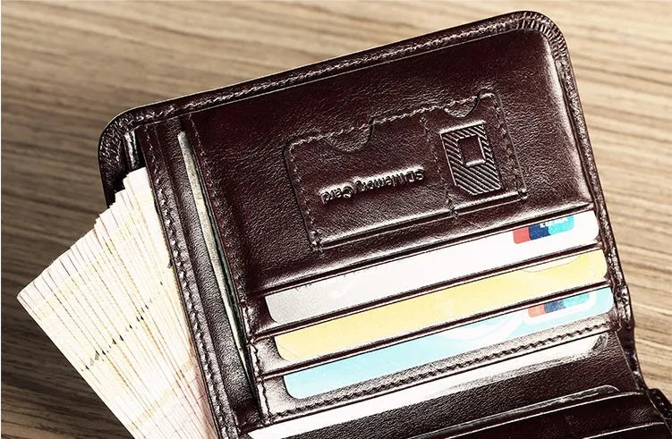 Men's black leather wallet open showing internal card slots, note compartment, and change section.
