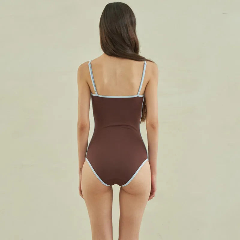 Brown women's triangle one-piece swimsuit made from nylon fabric.