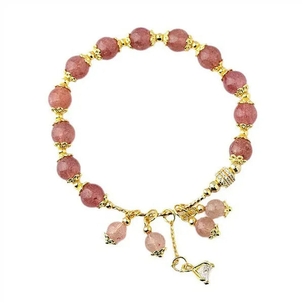 Pink heart-shaped strawberry quartz and pearl women's bracelet on a wrist.