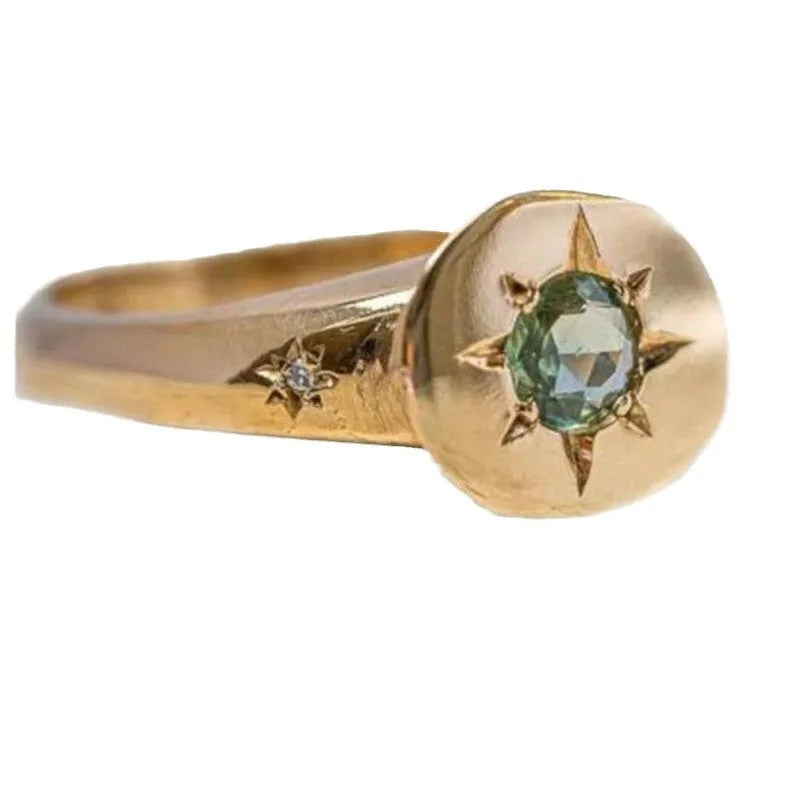 Gold star-shaped ring with asterism zircon on adjustable band.